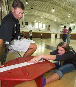 Physical education teacher Allen Harrell works with Krysta Styons in the MATCH Wellness program at Chowan Middle School in Tyner.