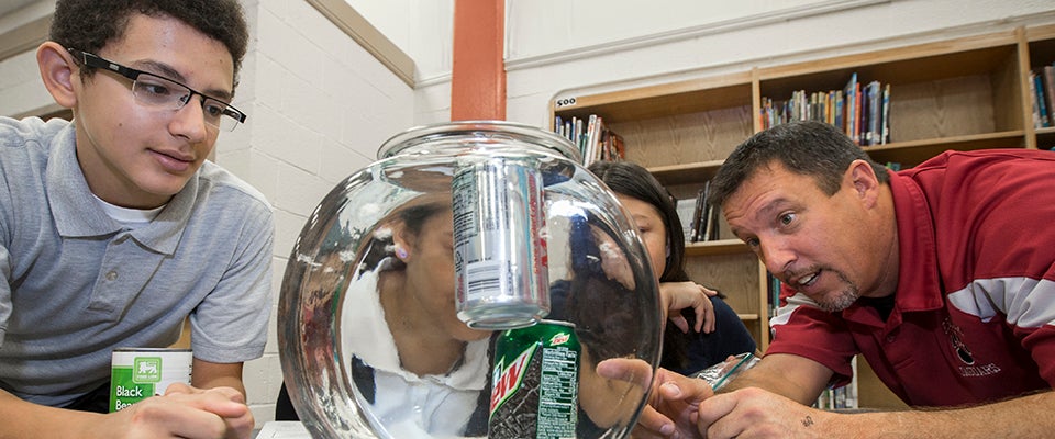 Students at E.B. Aycock Middle School in Greenville assess the nutritional value of different foods, including measuring the sugar content in soft drinks.