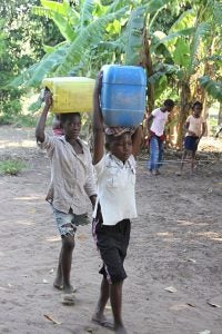 Children often walk long distances in their bare feet in Mozambique, making them at risk for infection and disease.