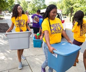 Members of student group Thrift Me Pretty help students move in at Jarvis Hall.