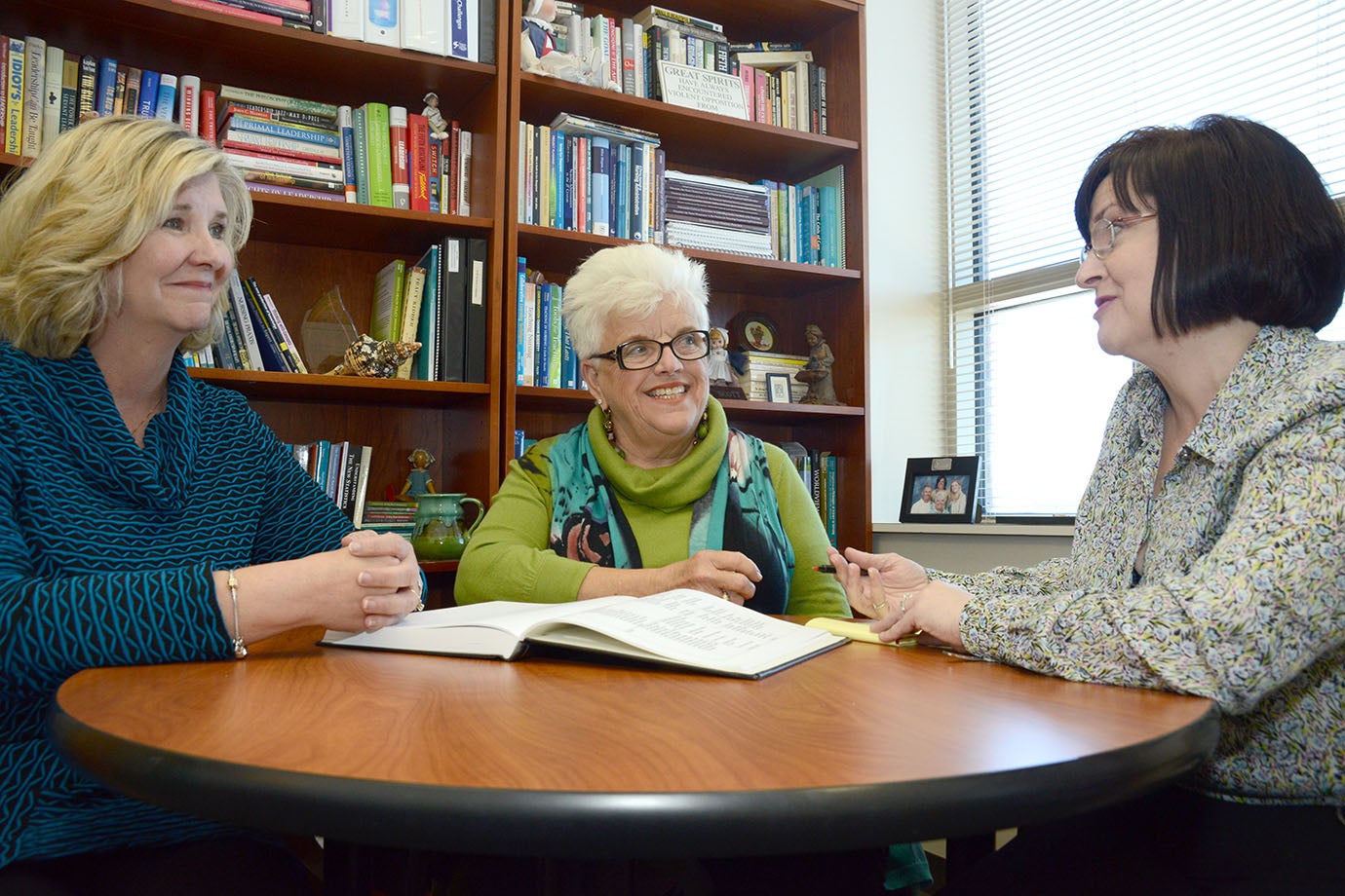 Left to right, Dr. Patricia Crane, associate dean for research and creative activities in the College of Nursing, speaks with PhD program Director Dr. Elaine Scott and Dr. Candace Harrington, a DNP to PhD student. (Photo by Conley Evans)