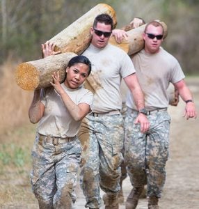 ECU Army Cadets Clara Sarmiento, at left, Jacob Kriminger and Roberto Garcia work as a team on the obstacle course at ECU's West Research Campus.