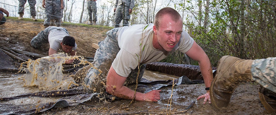   (Video by Rich Klindworth, ECU News Services)   ECU Army Cadet Christopher Rudkowski hugs the ground on the belly crawl part of the obstacle course. This obstacle is designed to replicate soldiers moving under fire by crawling no more than 16 inches above the ground and beneath an obstacle to move into a better position to engage the enemy without exposing themselves.