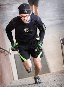 Seth Brown runs up a set of stairs during a morning workout. Storm the Stadium participants will climb 3,200 steps inside the stadium.