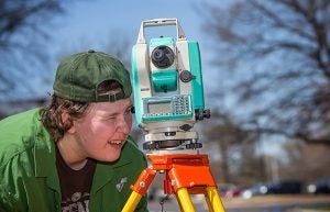 Kristina Hill uses a total station to record the coordinates of possible underground objects.