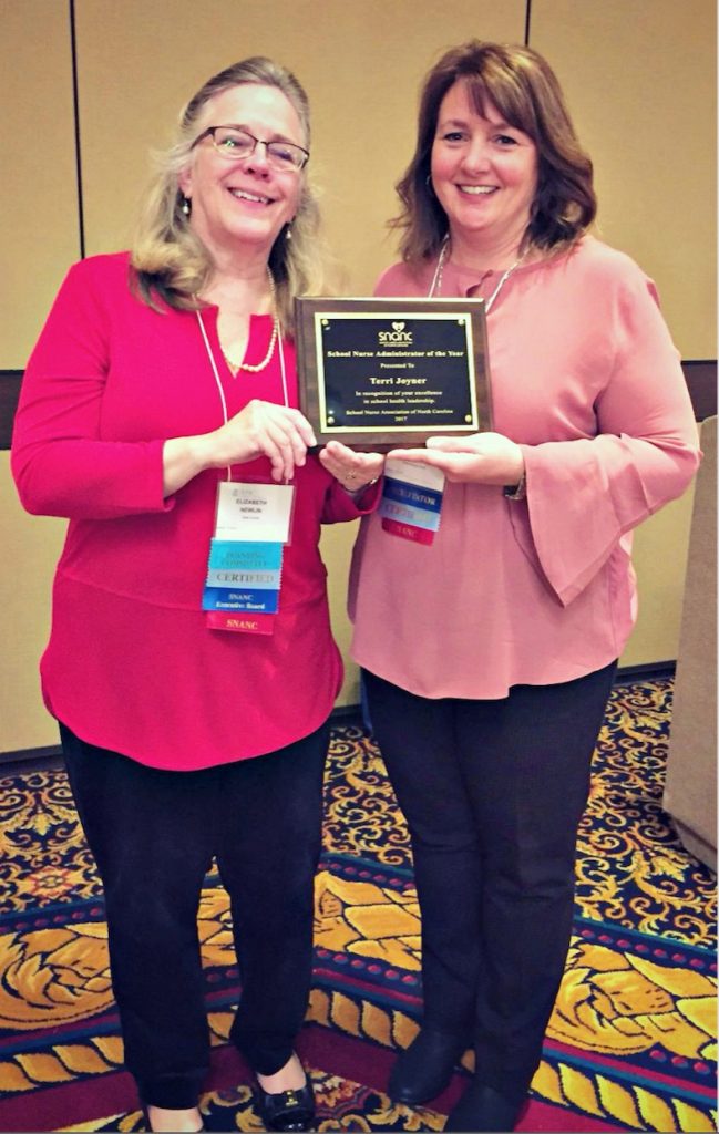 Liz Newlin, former president of the School Nurse Association of North Carolina (left), presents Terri Joyner (right) with the 2017 School Nurse Administrator of the Year Award.