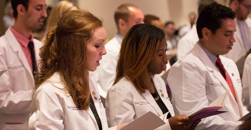 The newest Brody Scholars recite the Medical Student Pledge of Ethics with their classmates during the medical school’s annual white coat ceremony.