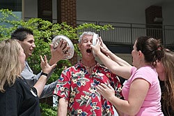 Students surround Bob Green, clinical assistant professor of nursing, as he takes two pies in the face from students who bid $100. (Editor's note: Tina Vandiford Roberson passed away on June 24, 2008 after a courageous battle with cancer). Photo by Cliff