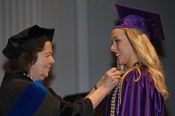 At right, Bethany Bartholomew of Greenville, a new bachelor's of science in nursing graduate, is pinned at convocation by associate professor of nursing Josie Bowman. Photo by Cliff Hollis.