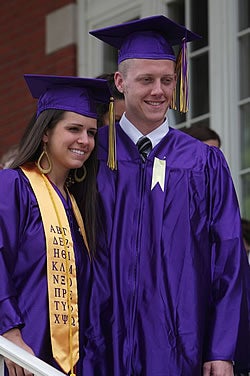 Anna Tsumas of Troutman and Christopher Trumbo of Apex pose for a photo following convocation outside Wright Auditorium.