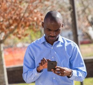 Ogaga Tebehaevu, an ECU Office of Environmental Health & Safety employee, tests the app’s ability to directly contact campus police.
