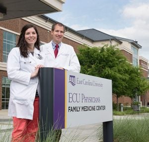 ECU Family Medicine residency director Dr. Jonathon Firnhaber & resident Dr. Meghan Scott pose outside of the facility. A bequest of $1 million will support medical students working in the ECU Family Medicine Center on obesity and/or nutrition. (Photo by Gretchen Baugh)
