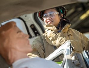 Brody student DT Nguyen prepares to extract a simulation patient from a wrecked vehicle