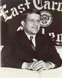 Chairman of the East Carolina College Board of Trustees Robert Burren Morgan, sits at a table in front of an ECC banner in 1967. (Photos courtesy Joyner Library Digital Collection)