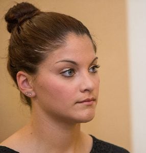 Lauren Pierce listens to remarks during the Veterans Graduate Recognition Ceremony.