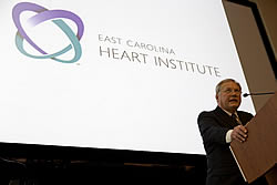 Dr. W. Randolph Chitwood Jr. speaks during dedication of the new East Carolina Heart Institute Dec. 11. Chitwood, a heart surgeon at East Carolina University, is director of the institute. Photo by Cliff Hollis