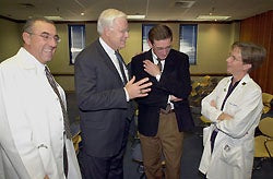 ECU Chancellor Richard R. Eakin (second from left) congratulates Drs. Peter Kragel and Ann Jobe on their new interim roles, as Dr. James A. Hallock, vice chancellor for health sciences and medical dean, looks on at left.