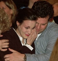 Lauren Ale gets a hug from her husband, Nathan Hull, after learning she will do her family medicine residency at Carolinas Medical Center in Charlotte. Photo by Cliff Hollis.