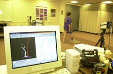 A 3-D image of the walking pattern of ECU patient Carolyn Knuckey, right, is shown on the computer in the Movement Science Laboratory at the School of Allied Health Sciences. Photo by Cliff Hollis