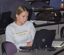 Second-year medical student Renee Carroll has her laptop plugged in while studying in one of the new SMART Classrooms at the Brody Medical Sciences Building. Photo by Cliff Hollis