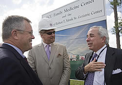 From left, ECU trustees Bruce Austin, Robert Hill and David Brody talk during the groundbreaking for the Eastern Carolina Family Medicine Center. Photo by Cliff Hollis