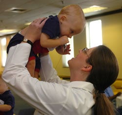 Dr. Christy Isler holds Samuel Beasley. A year ago, she delivered Samuel and his twin brother, Issac. Photo by Cliff Hollis