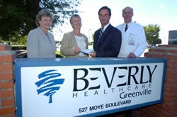 Hal Garland, center right, executive director of Beverly Healthcare in Greenville, presents a check for $101,000 to Dr. Valerie Gilchrist, center left, chairman of the ECU Department of Family Medicine, to fund geriatric teaching programs.