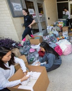 Students sort supplies donated for shelter residents.