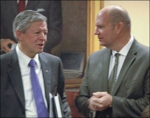 ECU Chancellor Steve Ballard, left, speaks with Harry Smith, chair of the UNC Board of Governors Committee on Budget and Finance during the Dec. 5 meeting in Chapel Hill. (Photo by Steve Tuttle)