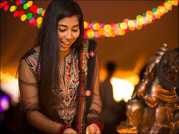 At the Diwali festival on the ECU brickyard, Priya Birdi examines the table on which Diya lamps illustrate light replacing darkness.