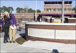 Ann Holland gives her husband Terry a hug during the event recognizing his contributions to the university.