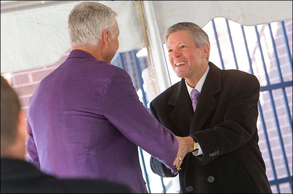 ECU Chancellor Steve Ballard, right, congratulates Holland at the recognition ceremony.