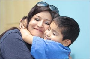 Six-year-old heart surgery recipient Emmanuel “Sebastian” Viscarra hugs his mother, Victoria Villca.