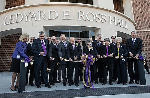 ECU, state and local officials, along with Dr. Ledyard Ross and his wife, Alta, center, cut the ribbon Friday, Oct. 12, on Ross Hall, the new home of the ECU School of Dental Medicine. 