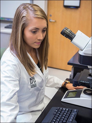 Senior exercise physiology major Blaire Conner assists in the chronic pain study.