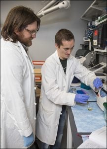 Bridges works with graduate student Jason Hoggard on isolating DNA.