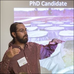 ECU student Scott Jones explains his research about tadpoles changing shape to avoid being eaten.