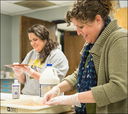 Photography professor Angela Wells, right, incorporated an alternative printmaking technique into her class, thanks to a grant from the Faculty Senate.