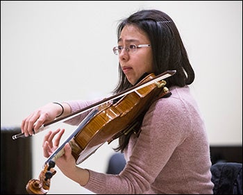 Winter Workshop participant Mengwen Zhao practices with the ensemble during the workshop.