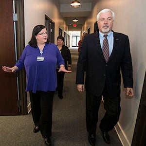 Angela Anderson, university registrar, and Dr. Rick Niswander, vice chancellor for administration and finance, tour the new registrar's office in downtown Greenville.