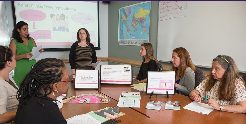 Pictured below, Essie Torres, left, and Alice Richman teach trainees to present education clinics in breast health. Torres and Richman conducted 12 hours of training for the group.