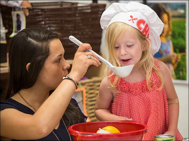 Playtime at the center is preschool teacher Jessica Pate, left, with preschooler and budding chef Olivia Flowers.