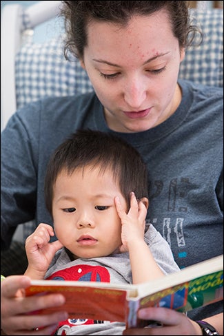 ECU junior Maddy Day reads "Goodnight Moon" to Grant Zou. Day is majoring in child life.