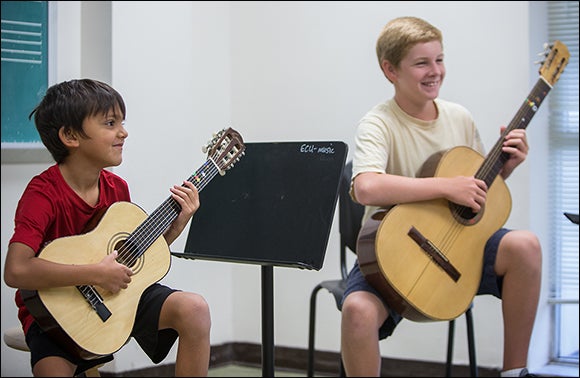 Pranab Mitra, left, and Ross Pennington listen to instruction during the ECU Guitar Festival.