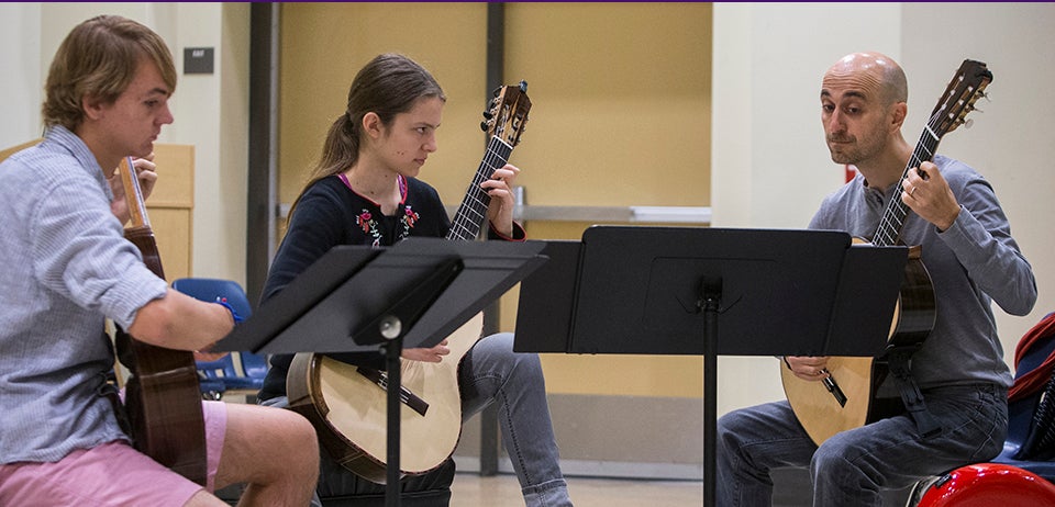 Pictured below, left to right, Sean McCrary and Eliza Balmuth work with SoloDuo guitarist Matteo Mela. McCrary and Balmuth traveled from Texas to participate in the festival.