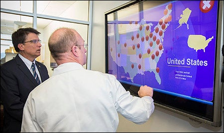 N.C. Gov. Pat McCrory, left, and Dr. Wiley Nifong examine an interactive display illustrating that ECU has trained surgeons from 33 states in the use of the robotic da Vinci Surgical System.