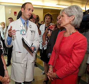 Dr. Christopher Porterfield, an ECU cardiology fellow, explains how he uses an iPad in his practice to Kathleen Sebelius, U.S. secretary of health and human services, during a Monday, May 23, tour of the East Carolina Heart Institute at Pitt County Memorial Hospital.