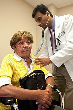 Dr. Sunil Sharma examines Beatriz Ramirez in the new ECU pulmonary hypertension clinic. Photo by Cliff Hollis