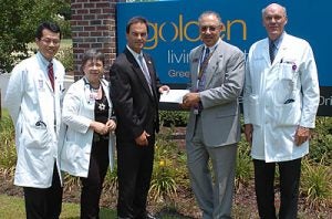 From left, Dr. Tae Joon Lee, medical director at Golden Living Center; Maria Knupp, ECU family nurse practitioner; Hal Garland, executive director of Golden Living Center; Dr. Paul Cunningham, dean of the Brody School of Medicine; and Dr. Kenneth Steinweg, chair of family medicine, pose in front of Golden Living Center in Greenville. The center gave $116,435 to ECU to support teaching programs at the center. Photo by Doug Boyd