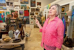 Karen Krupa shows some of the items in the Inner Banks Artisans' Center in Washington. Photo by Cliff Hollis, ECU News Services.